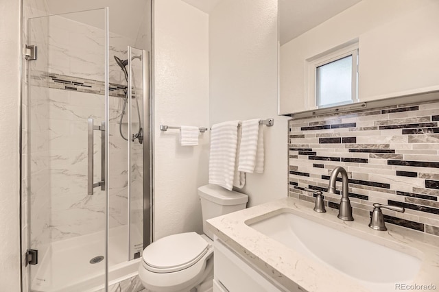 6348 S Independence St, Littleton, CO 80123 - bathroom featuring a marble finish shower, vanity, and backsplash