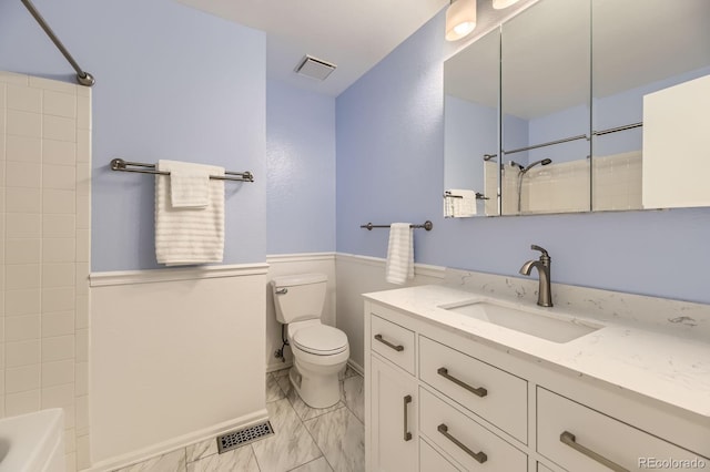 6348 S Independence St, Littleton, CO 80123 - bathroom with vanity, wainscoting, marble finish floors, and shower / bathtub combination