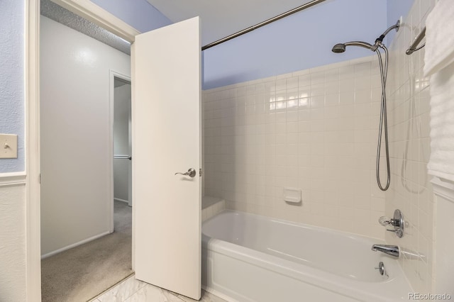 6348 S Independence St, Littleton, CO 80123 - bathroom featuring shower / bath combination and marble look tiles