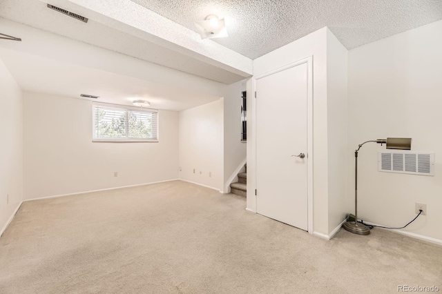 6348 S Independence St, Littleton, CO 80123 - basement with light colored carpet, stairs, and a textured ceiling