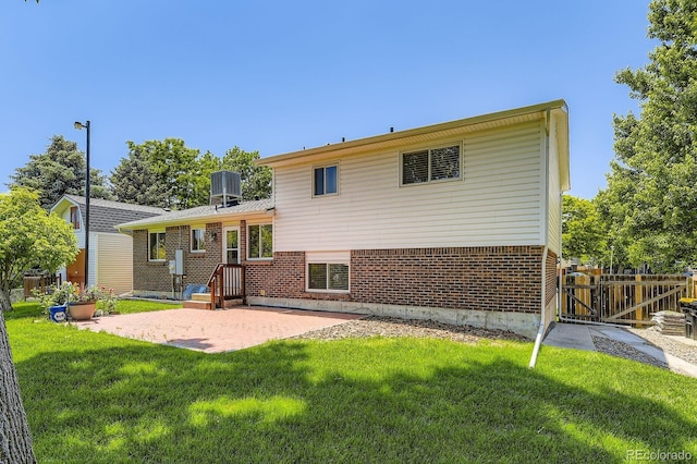 6348 S Independence St, Littleton, CO 80123 - rear view of property with brick siding and a patio