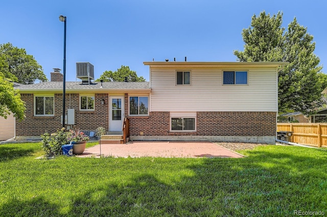 6348 S Independence St, Littleton, CO 80123 - back of house featuring brick siding, a patio, and a chimney