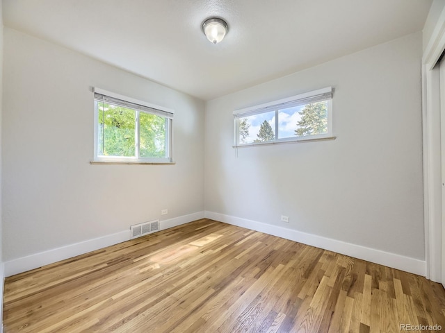 50 Yarrow St, Lakewood, CO 80226 - unfurnished room with plenty of natural light, baseboards, and light wood-type flooring