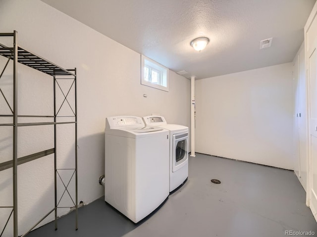 50 Yarrow St, Lakewood, CO 80226 - washroom featuring washing machine and clothes dryer and a textured ceiling