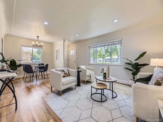 50 Yarrow St, Lakewood, CO 80226 - living room featuring healthy amount of natural light, a chandelier, light wood-type flooring, baseboards, and recessed lighting