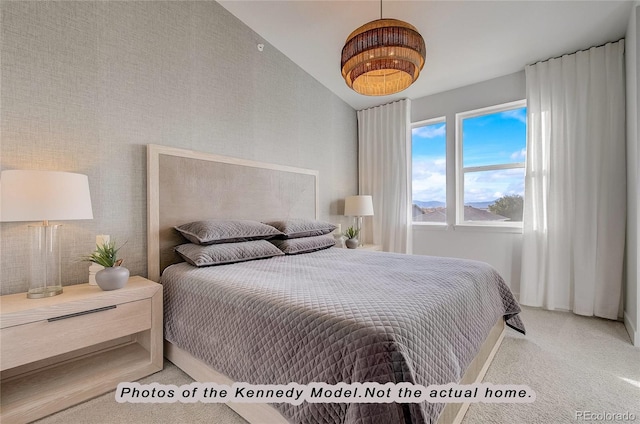 bedroom with vaulted ceiling and carpet floors