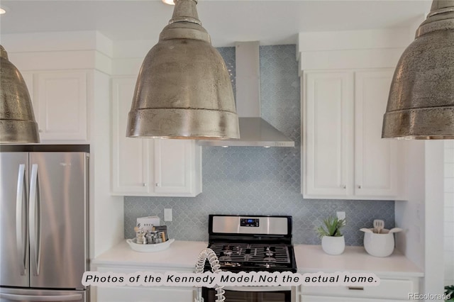 kitchen featuring tasteful backsplash, wall chimney range hood, stainless steel appliances, and white cabinets