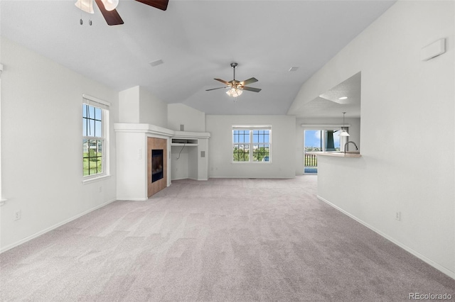 7713 S Zante Ct, Aurora, CO 80016 - unfurnished living room featuring ceiling fan, plenty of natural light, light carpet, and vaulted ceiling