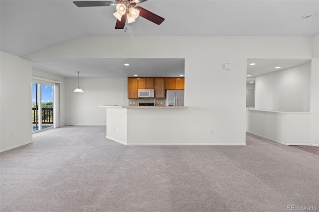 7713 S Zante Ct, Aurora, CO 80016 - unfurnished living room featuring light colored carpet, a ceiling fan, recessed lighting, and vaulted ceiling