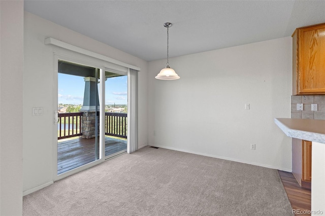 7713 S Zante Ct, Aurora, CO 80016 - unfurnished dining area featuring baseboards and carpet