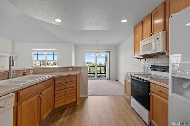 7713 S Zante Ct, Aurora, CO 80016 - kitchen featuring white appliances, light wood finished floors, plenty of natural light, tasteful backsplash, and a textured ceiling