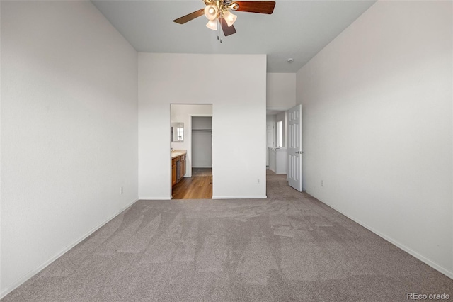 7713 S Zante Ct, Aurora, CO 80016 - unfurnished bedroom with carpet, a ceiling fan, ensuite bath, and a walk in closet