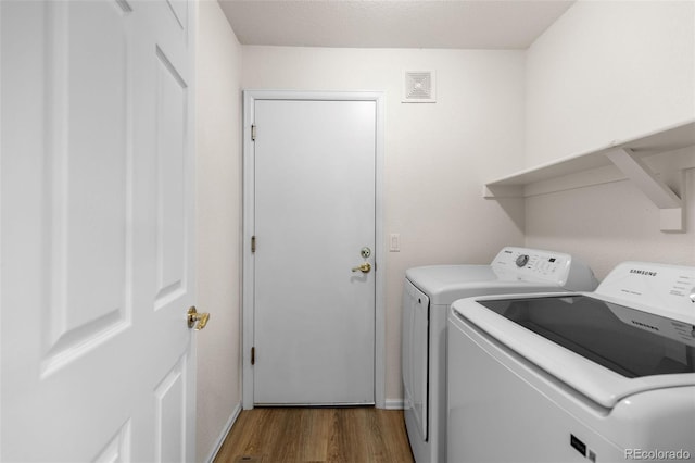 7713 S Zante Ct, Aurora, CO 80016 - washroom featuring separate washer and dryer and wood finished floors