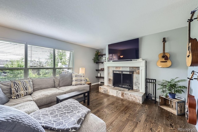 3378 Mowry Pl, Westminster, CO 80031 - living room featuring a fireplace, wood finished floors, a textured ceiling, and baseboards