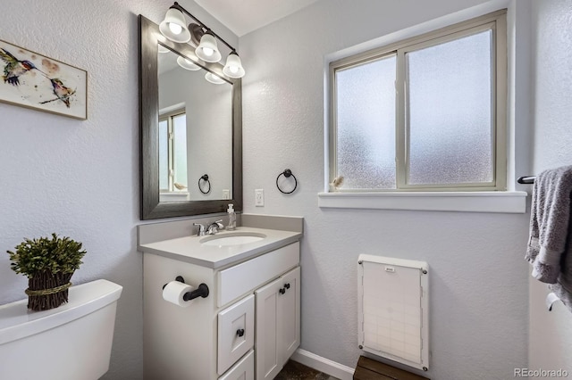 3378 Mowry Pl, Westminster, CO 80031 - half bathroom with toilet, plenty of natural light, and vanity