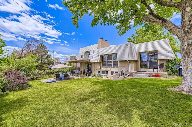 3378 Mowry Pl, Westminster, CO 80031 - back of property featuring a patio, a chimney, a yard, and brick siding