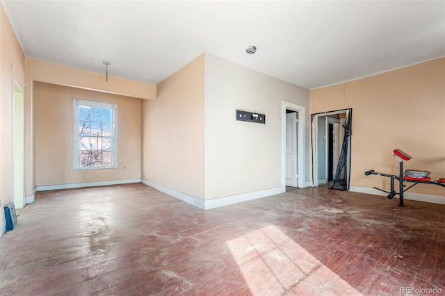 unfurnished room featuring baseboards