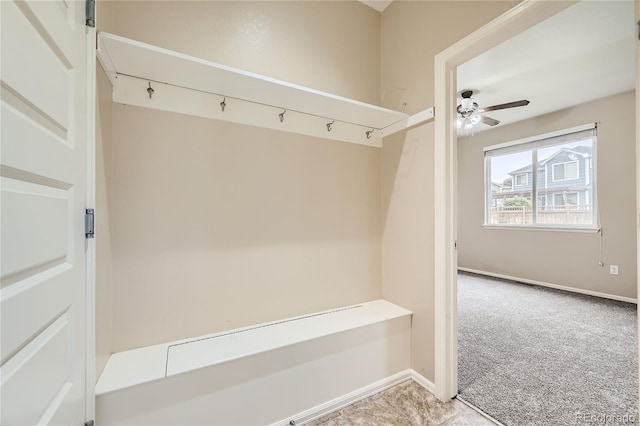 mudroom with ceiling fan and light carpet