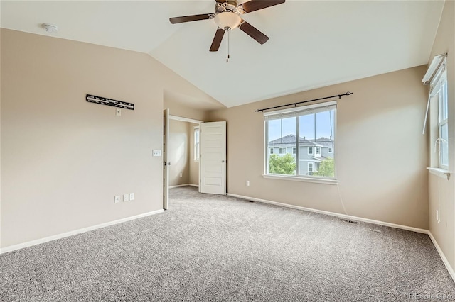 carpeted empty room with ceiling fan and lofted ceiling