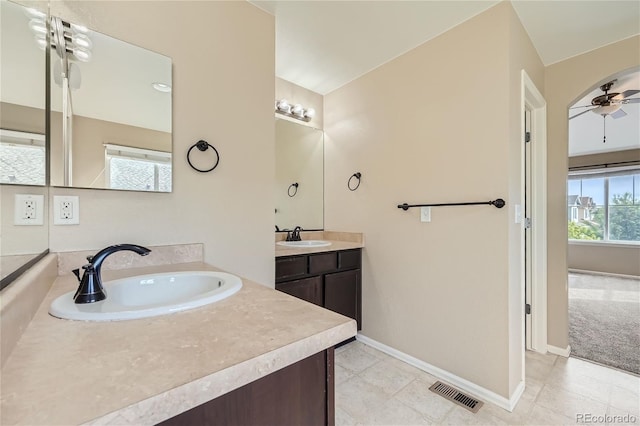 bathroom featuring vanity, a healthy amount of sunlight, and ceiling fan