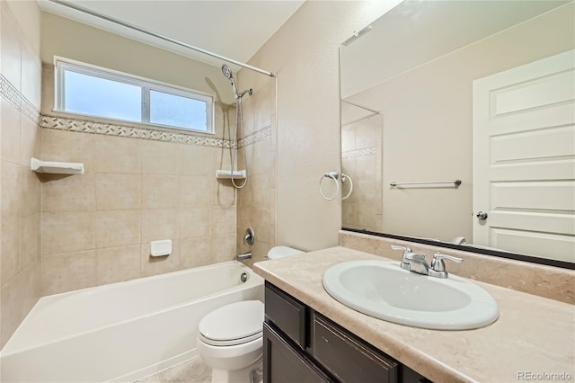 full bathroom with vanity, toilet, and tiled shower / bath