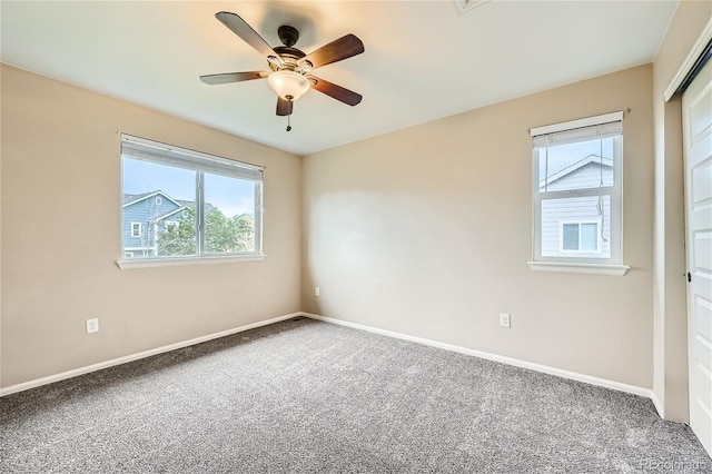 carpeted empty room featuring ceiling fan