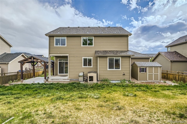 back of property with a yard, a gazebo, a patio area, and a storage unit