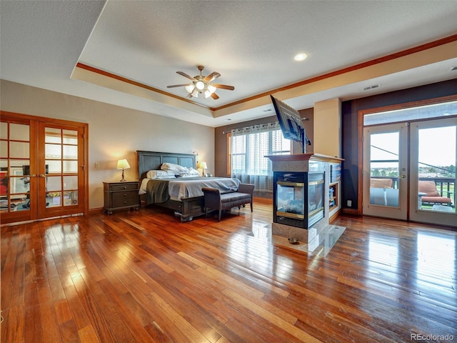 6533 S Quemoy Way, Aurora, CO 80016 - bedroom featuring a tray ceiling, multiple windows, french doors, and access to exterior