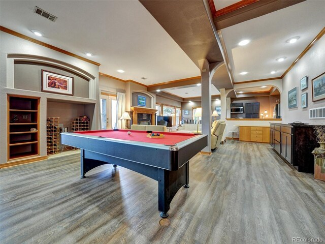 6533 S Quemoy Way, Aurora, CO 80016 - playroom featuring light wood-style flooring, visible vents, arched walkways, ornamental molding, and pool table