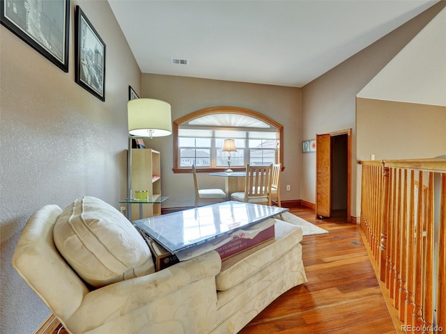 6533 S Quemoy Way, Aurora, CO 80016 - living area featuring baseboards, visible vents, and wood finished floors