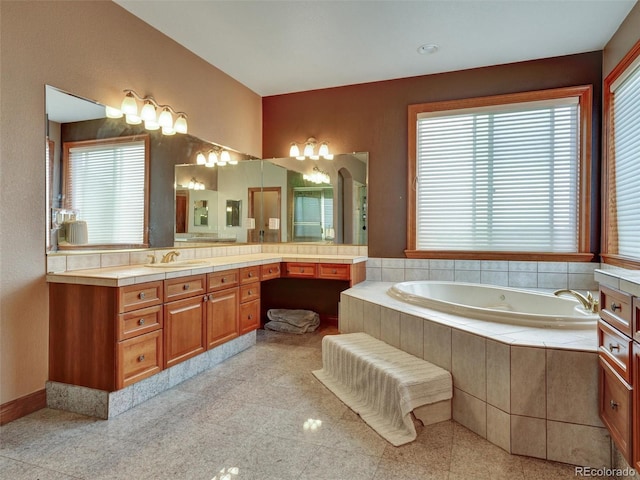 6533 S Quemoy Way, Aurora, CO 80016 - bathroom featuring vanity, a garden tub, and granite finish floor