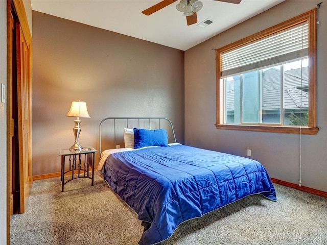 6533 S Quemoy Way, Aurora, CO 80016 - carpeted bedroom featuring baseboards, a ceiling fan, and visible vents