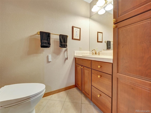6533 S Quemoy Way, Aurora, CO 80016 - bathroom featuring toilet, baseboards, tile patterned floors, and vanity