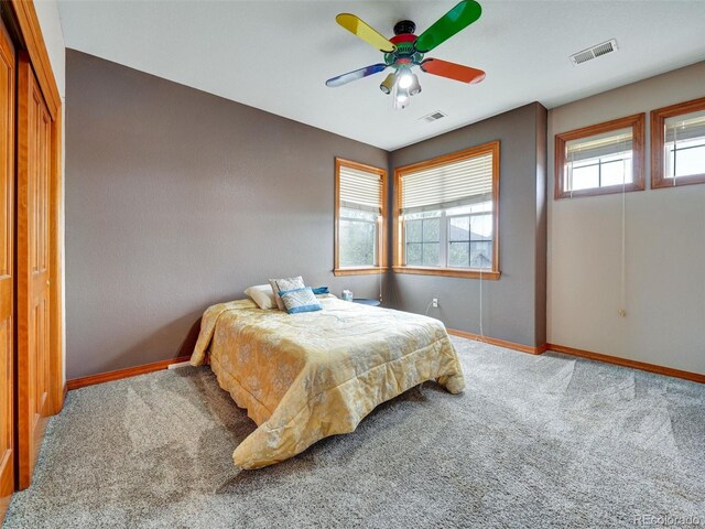 6533 S Quemoy Way, Aurora, CO 80016 - carpeted bedroom with baseboards, ceiling fan, and visible vents