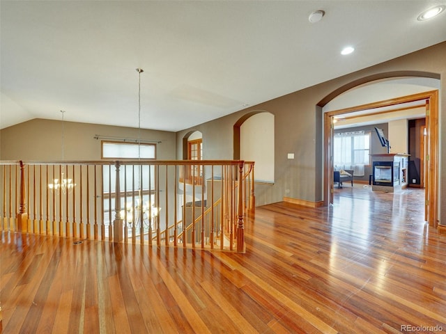 6533 S Quemoy Way, Aurora, CO 80016 - interior space with arched walkways, an upstairs landing, recessed lighting, and wood finished floors