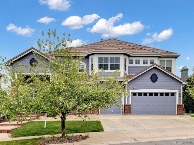 6533 S Quemoy Way, Aurora, CO 80016 - view of front of house with driveway, brick siding, and a tiled roof