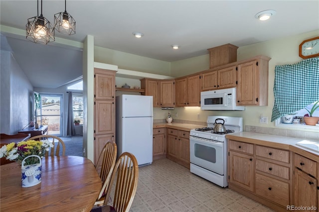 kitchen featuring white appliances, decorative light fixtures, light countertops, light floors, and light brown cabinets