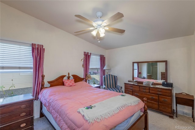 bedroom with a ceiling fan, lofted ceiling, and light colored carpet