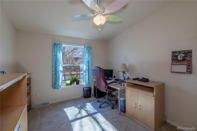 home office featuring light carpet, baseboards, visible vents, and ceiling fan