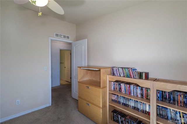 interior space featuring a ceiling fan, baseboards, visible vents, and carpet flooring