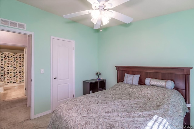 carpeted bedroom featuring a ceiling fan and visible vents