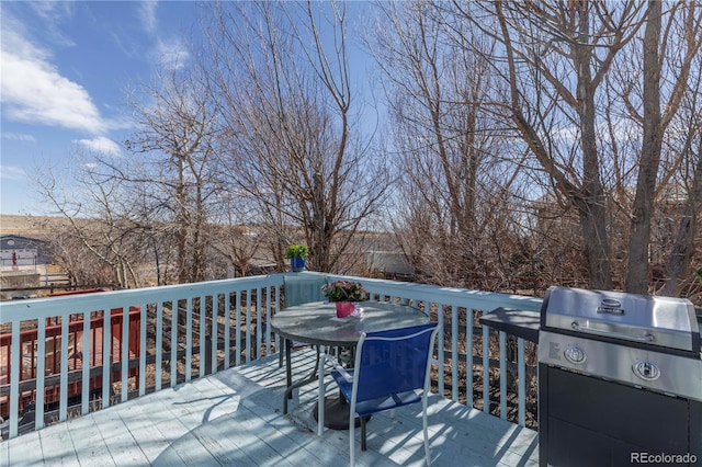 wooden terrace featuring a grill