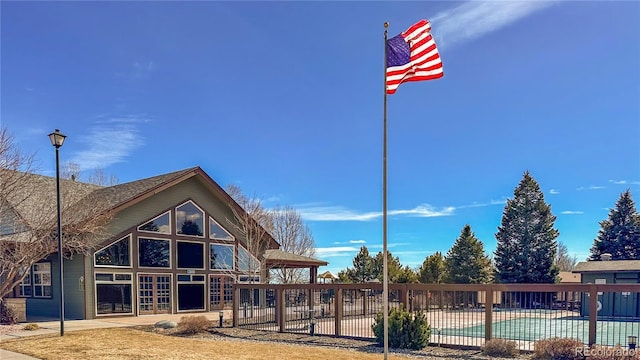 exterior space featuring a patio area, a community pool, and fence