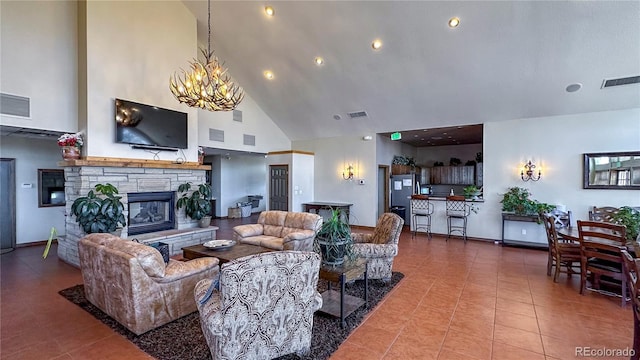 living area with a stone fireplace, tile patterned flooring, visible vents, and a notable chandelier