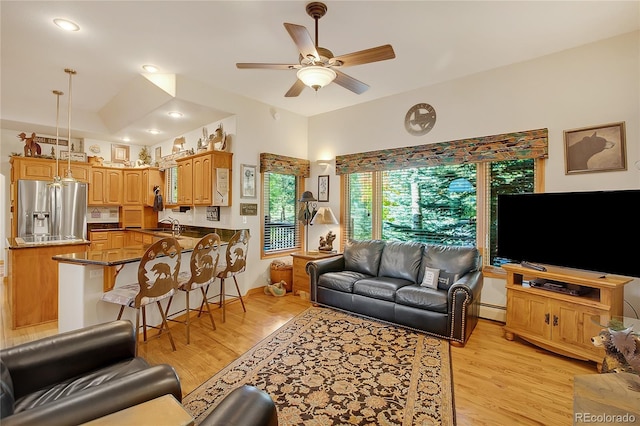 living area featuring recessed lighting, a baseboard radiator, light wood-type flooring, and ceiling fan