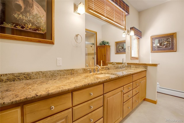 bathroom with a sink, a shower stall, a baseboard heating unit, and double vanity