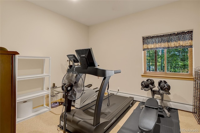 exercise area with a baseboard heating unit, baseboards, and carpet floors