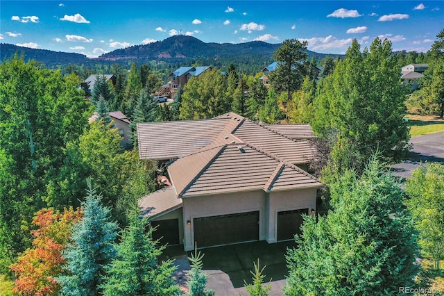 aerial view featuring a forest view and a mountain view