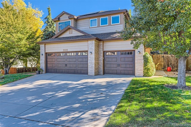 view of front facade featuring a front yard and a garage