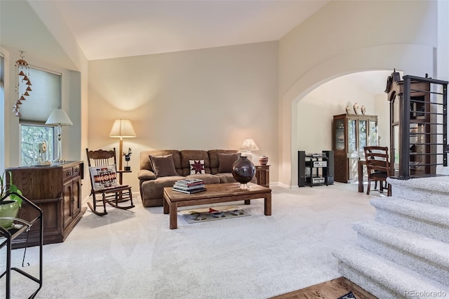 living room with light carpet and vaulted ceiling